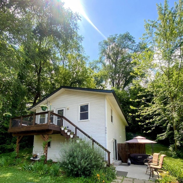 305 N Blackhawk Dr, Byron, IL 61010 - view of home's exterior with stairs, a deck, and a patio