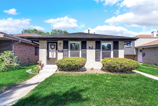 14112 S Hoxie Ave, Burnham, IL 60633 - view of front of house featuring brick siding, a front yard, and a shingled roof