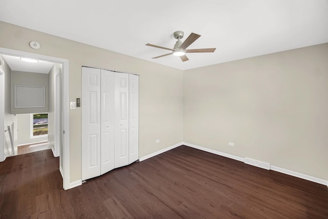 14112 S Hoxie Ave, Burnham, IL 60633 - unfurnished bedroom with dark wood finished floors, a closet, and a ceiling fan