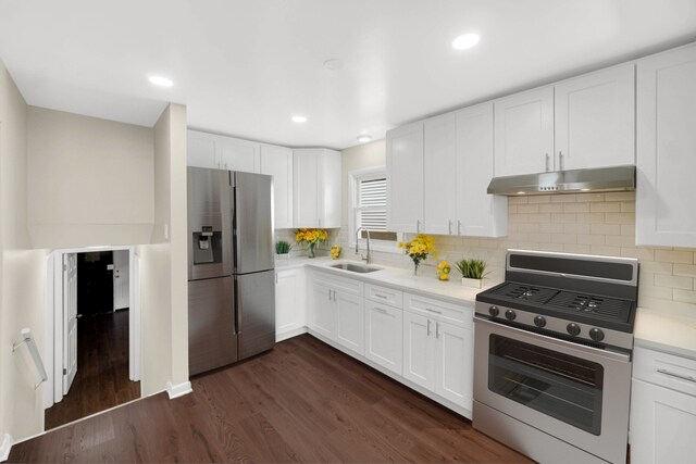 14112 S Hoxie Ave, Burnham, IL 60633 - kitchen with under cabinet range hood, dark wood finished floors, white cabinetry, decorative backsplash, and recessed lighting