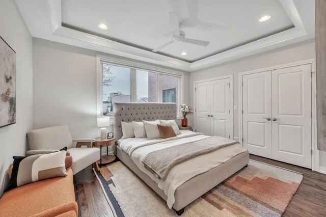 2423 W Erie St, Chicago, IL 60612 - bedroom with a tray ceiling, two closets, wood finished floors, ceiling fan, and recessed lighting