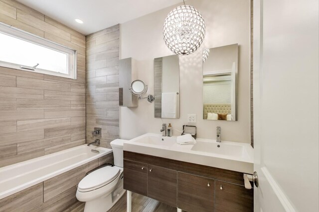 2423 W Erie St, Chicago, IL 60612 - full bath with double vanity, a chandelier, and tiled shower / bath