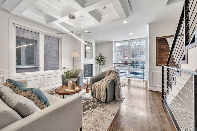 2423 W Erie St, Chicago, IL 60612 - living area with a decorative wall, a glass covered fireplace, stairway, beam ceiling, and ornamental molding