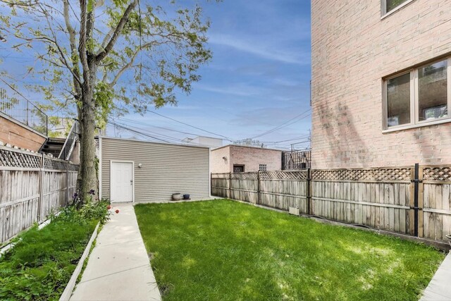 2423 W Erie St, Chicago, IL 60612 - fenced backyard featuring an outdoor structure