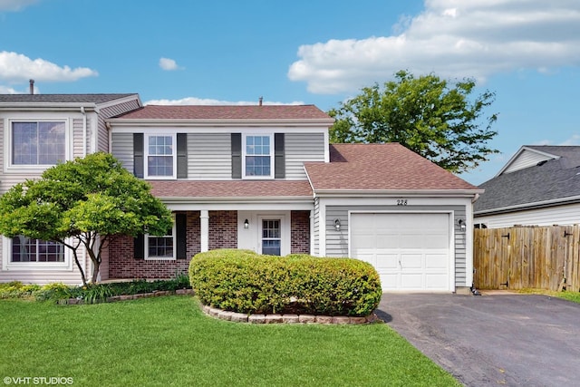 228 Dunton Ct, Mundelein, IL 60060 - traditional-style home with an attached garage, driveway, brick siding, and a shingled roof