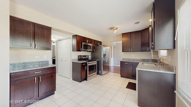 228 Dunton Ct, Mundelein, IL 60060 - kitchen with stainless steel appliances, light tile patterned floors, light stone counters, and dark brown cabinetry