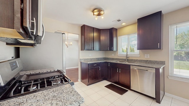 228 Dunton Ct, Mundelein, IL 60060 - kitchen with stainless steel appliances, healthy amount of natural light, light tile patterned floors, and dark brown cabinetry