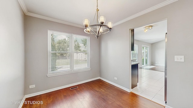 228 Dunton Ct, Mundelein, IL 60060 - spare room featuring a chandelier, crown molding, and hardwood / wood-style flooring