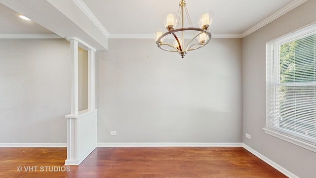 228 Dunton Ct, Mundelein, IL 60060 - unfurnished room with a chandelier, wood finished floors, crown molding, and ornate columns
