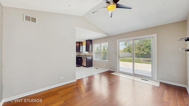 228 Dunton Ct, Mundelein, IL 60060 - unfurnished living room featuring a ceiling fan, light wood-style flooring, and vaulted ceiling