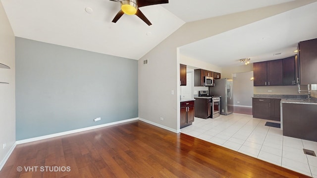 228 Dunton Ct, Mundelein, IL 60060 - kitchen featuring appliances with stainless steel finishes, light wood finished floors, a ceiling fan, lofted ceiling, and dark brown cabinets