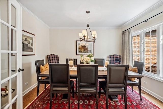 14 Southgate Ct Unit 14, Burr Ridge, IL 60527 - dining space featuring a chandelier, healthy amount of natural light, wood finished floors, crown molding, and french doors