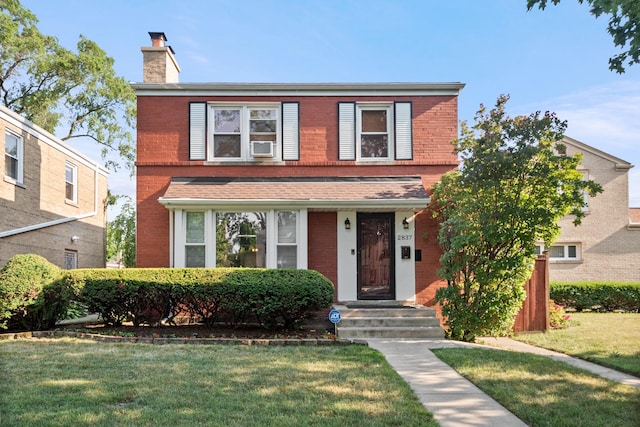 2837 W Coyle Ave, Chicago, IL 60645 - traditional-style house featuring a chimney, brick siding, a front lawn, and cooling unit