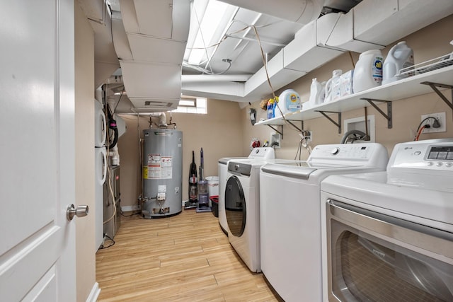 2837 W Coyle Ave, Chicago, IL 60645 - washroom featuring water heater, washer and clothes dryer, and light wood-type flooring