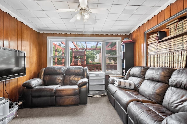 2837 W Coyle Ave, Chicago, IL 60645 - carpeted living room with wood walls and a ceiling fan