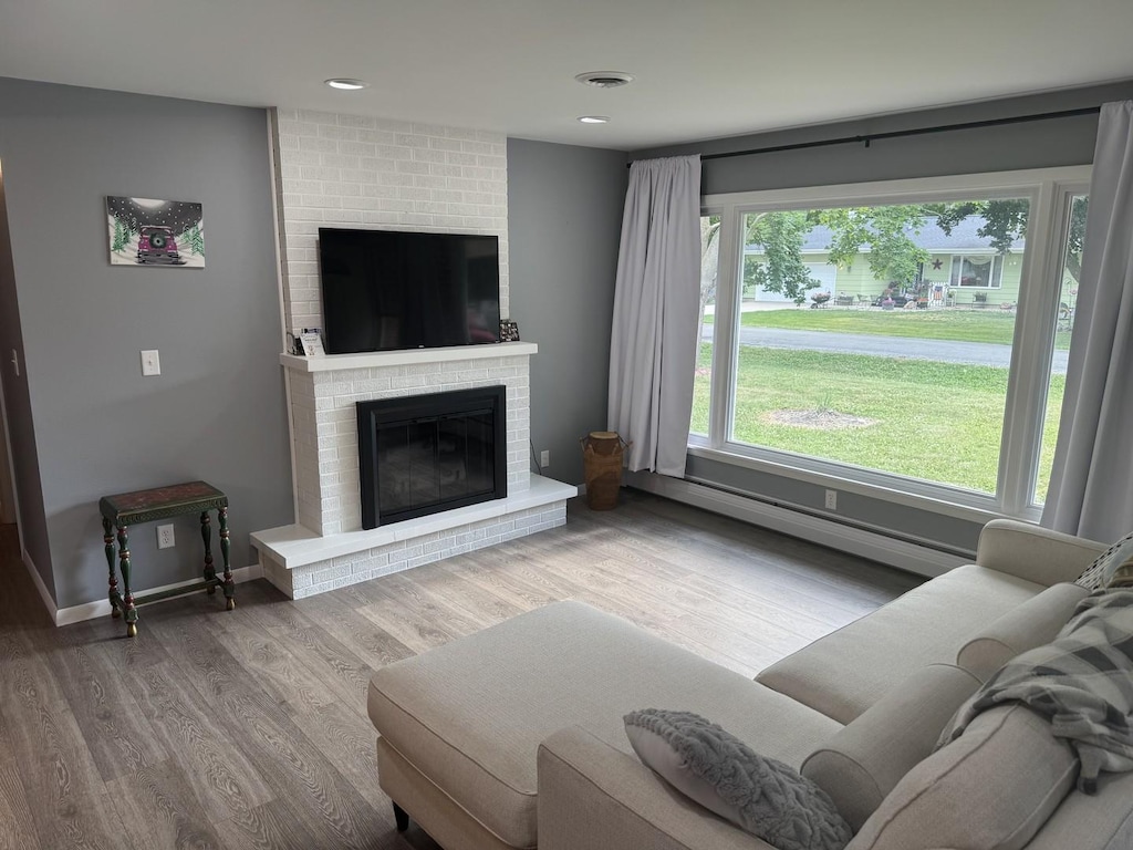 208 N Wisconsin St, Atwood, IL 61913 - living room featuring a fireplace, wood finished floors, and recessed lighting