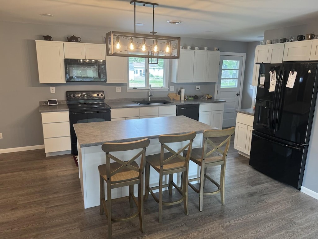 208 N Wisconsin St, Atwood, IL 61913 - kitchen featuring black appliances, white cabinetry, and dark wood-style flooring