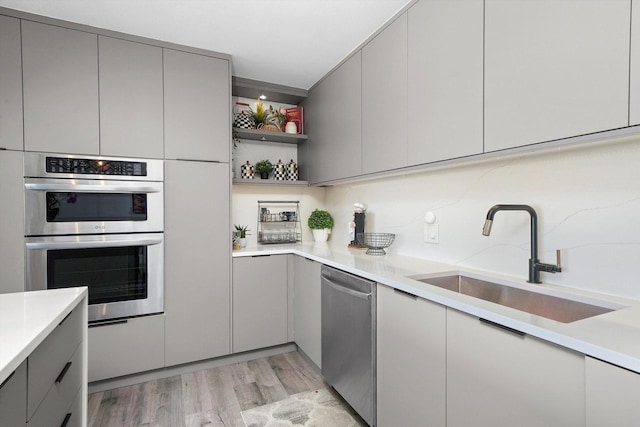 330 W Diversey Pkwy Unit 1606, Chicago, IL 60657 - kitchen with gray cabinetry, stainless steel appliances, light wood finished floors, and light countertops