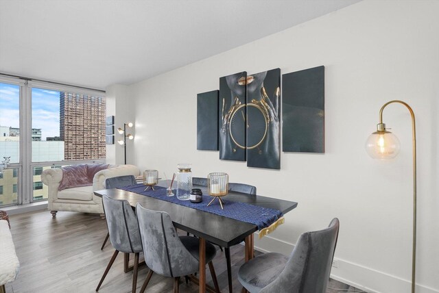 330 W Diversey Pkwy Unit 1606, Chicago, IL 60657 - dining area featuring wood finished floors and a wall of windows