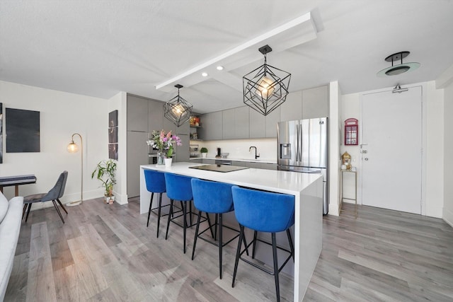 330 W Diversey Pkwy Unit 1606, Chicago, IL 60657 - kitchen with stainless steel refrigerator with ice dispenser, modern cabinets, a kitchen bar, and light wood-style flooring