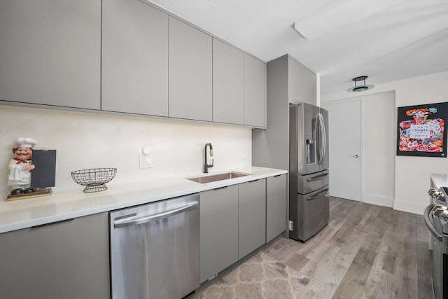 330 W Diversey Pkwy Unit 1606, Chicago, IL 60657 - kitchen with stainless steel appliances, gray cabinetry, light wood finished floors, and light countertops