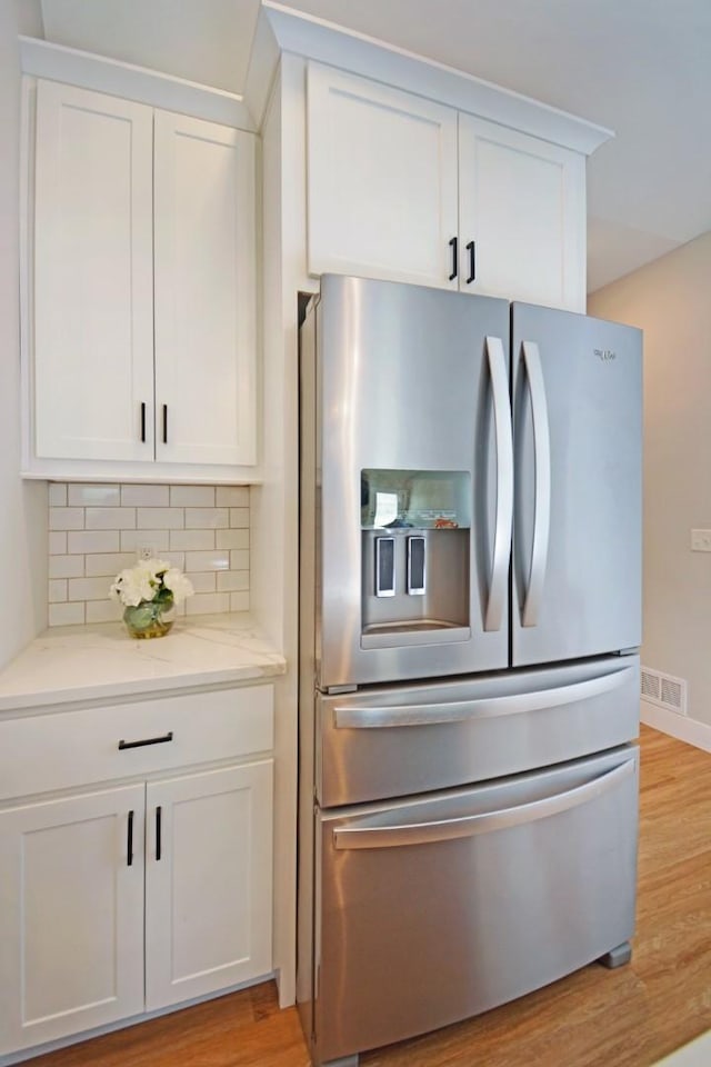 1723 Glenbridge Rd, Bloomington, IL 61704 - kitchen featuring stainless steel fridge with ice dispenser, light wood-type flooring, and white cabinetry