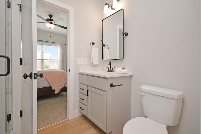 1723 Glenbridge Rd, Bloomington, IL 61704 - full bathroom featuring vanity, wood finished floors, a ceiling fan, and ensuite bathroom