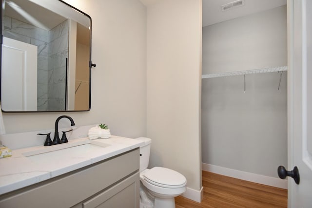 1723 Glenbridge Rd, Bloomington, IL 61704 - full bath with vanity, wood finished floors, a walk in closet, and a shower