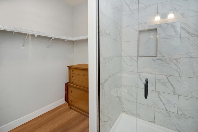 1723 Glenbridge Rd, Bloomington, IL 61704 - bathroom featuring wood finished floors, a shower stall, and a walk in closet