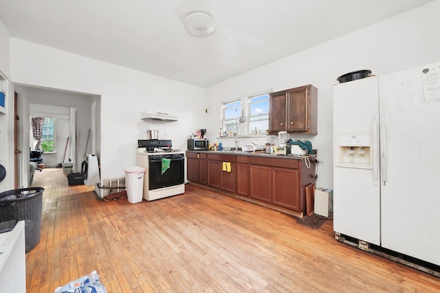5044 W Roscoe St, Chicago, IL 60641 - kitchen featuring white appliances, light wood-type flooring, healthy amount of natural light, and under cabinet range hood
