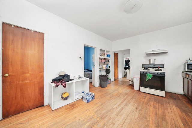 5044 W Roscoe St, Chicago, IL 60641 - kitchen with white gas range, stainless steel microwave, hardwood / wood-style floors, under cabinet range hood, and built in features