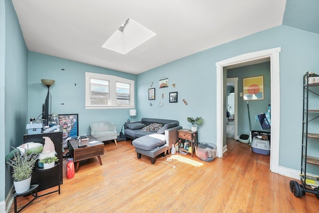 5044 W Roscoe St, Chicago, IL 60641 - living room featuring a skylight and wood finished floors