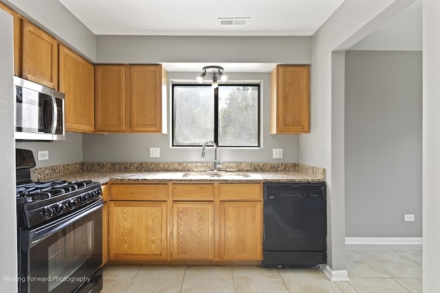 1249 Cunningham Dr Unit 2E, Calumet City, IL 60409 - kitchen featuring black appliances, light tile patterned flooring, stone counters, a chandelier, and brown cabinetry
