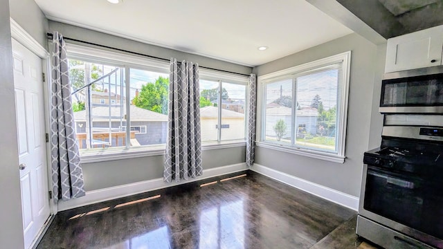 5937 W Eastwood Ave, Chicago, IL 60630 - unfurnished dining area featuring healthy amount of natural light, dark wood-style flooring, and recessed lighting