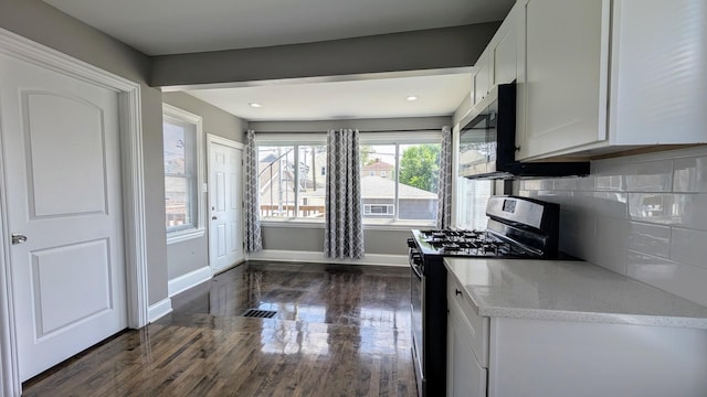 5937 W Eastwood Ave, Chicago, IL 60630 - kitchen with stainless steel appliances, dark wood-type flooring, white cabinetry, light stone countertops, and decorative backsplash