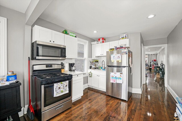 5937 W Eastwood Ave, Chicago, IL 60630 - kitchen with appliances with stainless steel finishes, white cabinetry, light countertops, dark wood-type flooring, and recessed lighting