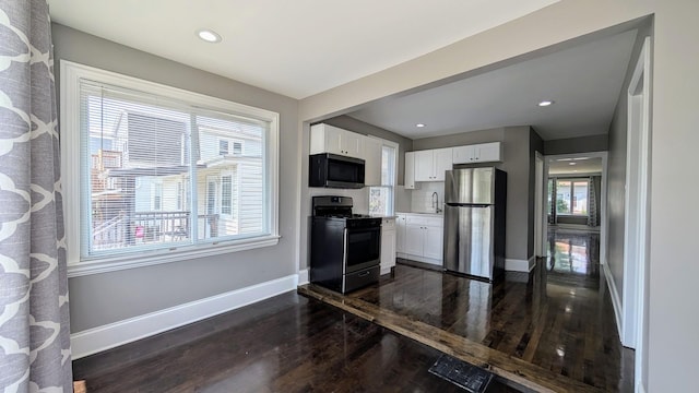 5937 W Eastwood Ave, Chicago, IL 60630 - kitchen featuring appliances with stainless steel finishes, dark wood-style flooring, white cabinets, recessed lighting, and light countertops
