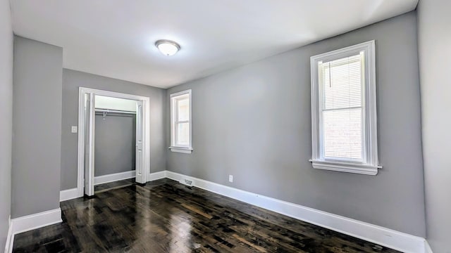 5937 W Eastwood Ave, Chicago, IL 60630 - unfurnished bedroom with dark wood finished floors and a closet