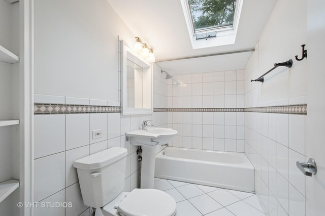 2111 Lake Ave, Wilmette, IL 60091 - bathroom featuring tile walls, bathing tub / shower combination, tile patterned floors, and a skylight