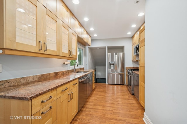 2111 Lake Ave, Wilmette, IL 60091 - kitchen featuring stainless steel appliances, light wood-style flooring, recessed lighting, glass insert cabinets, and dark stone counters