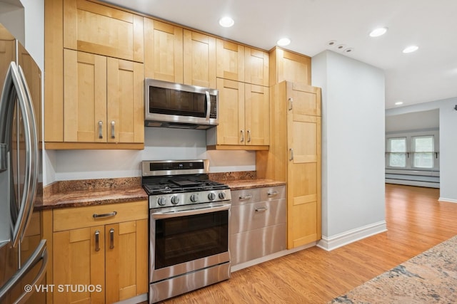 2111 Lake Ave, Wilmette, IL 60091 - kitchen featuring stainless steel appliances, light wood finished floors, stone counters, a baseboard heating unit, and recessed lighting
