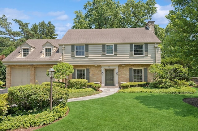 1054 Seneca Rd, Wilmette, IL 60091 - view of front of house with a front yard, a chimney, asphalt driveway, roof with shingles, and an attached garage