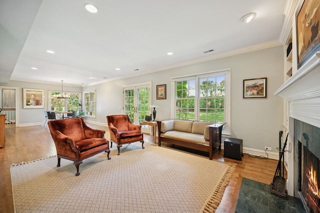 1054 Seneca Rd, Wilmette, IL 60091 - living room featuring a fireplace, wood finished floors, healthy amount of natural light, ornamental molding, and recessed lighting