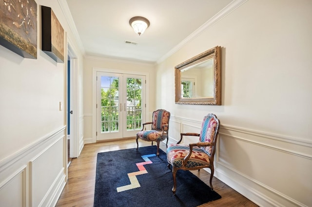 1054 Seneca Rd, Wilmette, IL 60091 - sitting room featuring french doors, ornamental molding, a decorative wall, light wood-style floors, and a wainscoted wall