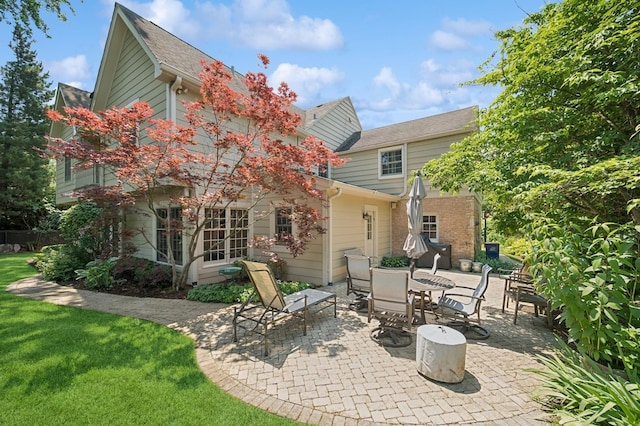 1054 Seneca Rd, Wilmette, IL 60091 - back of house with a patio and a lawn
