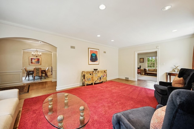 1054 Seneca Rd, Wilmette, IL 60091 - living area with arched walkways, wood finished floors, ornamental molding, a chandelier, and recessed lighting