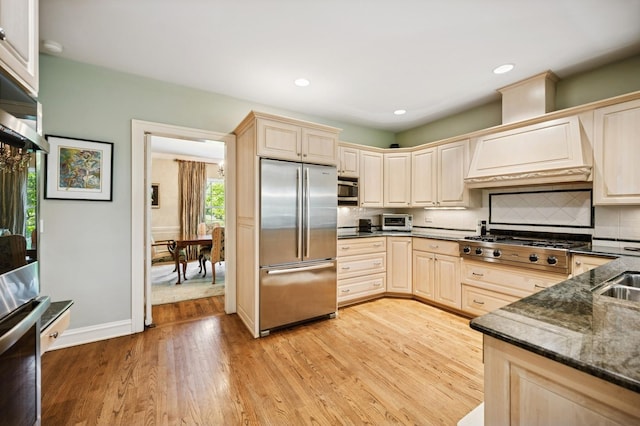 1054 Seneca Rd, Wilmette, IL 60091 - kitchen with stainless steel appliances, light wood-style flooring, tasteful backsplash, custom range hood, and recessed lighting