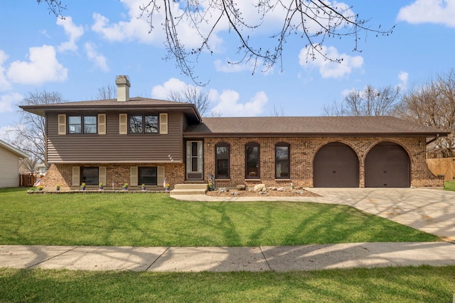 440 Charles Ct, South Elgin, IL 60177 - tri-level home featuring concrete driveway, brick siding, a garage, a chimney, and a front yard