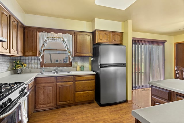 440 Charles Ct, South Elgin, IL 60177 - kitchen featuring freestanding refrigerator, light wood-style floors, light countertops, and backsplash