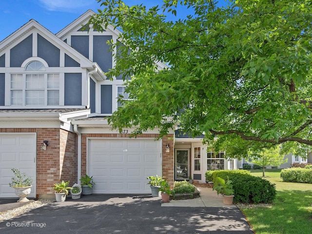673 Kingsbridge Dr, Carol Stream, IL 60188 - view of front of home featuring brick siding, driveway, an attached garage, and stucco siding
